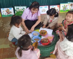 Hình ảnh cô và trẻ đang tham gia hoạt động ngoài trời